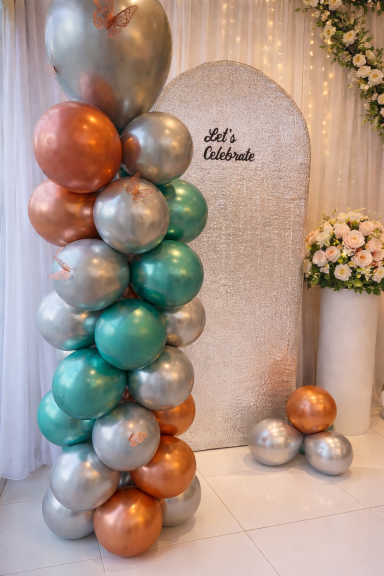 Metallic spiral patterned balloon column next to our silver sequinned sailboard backdrop